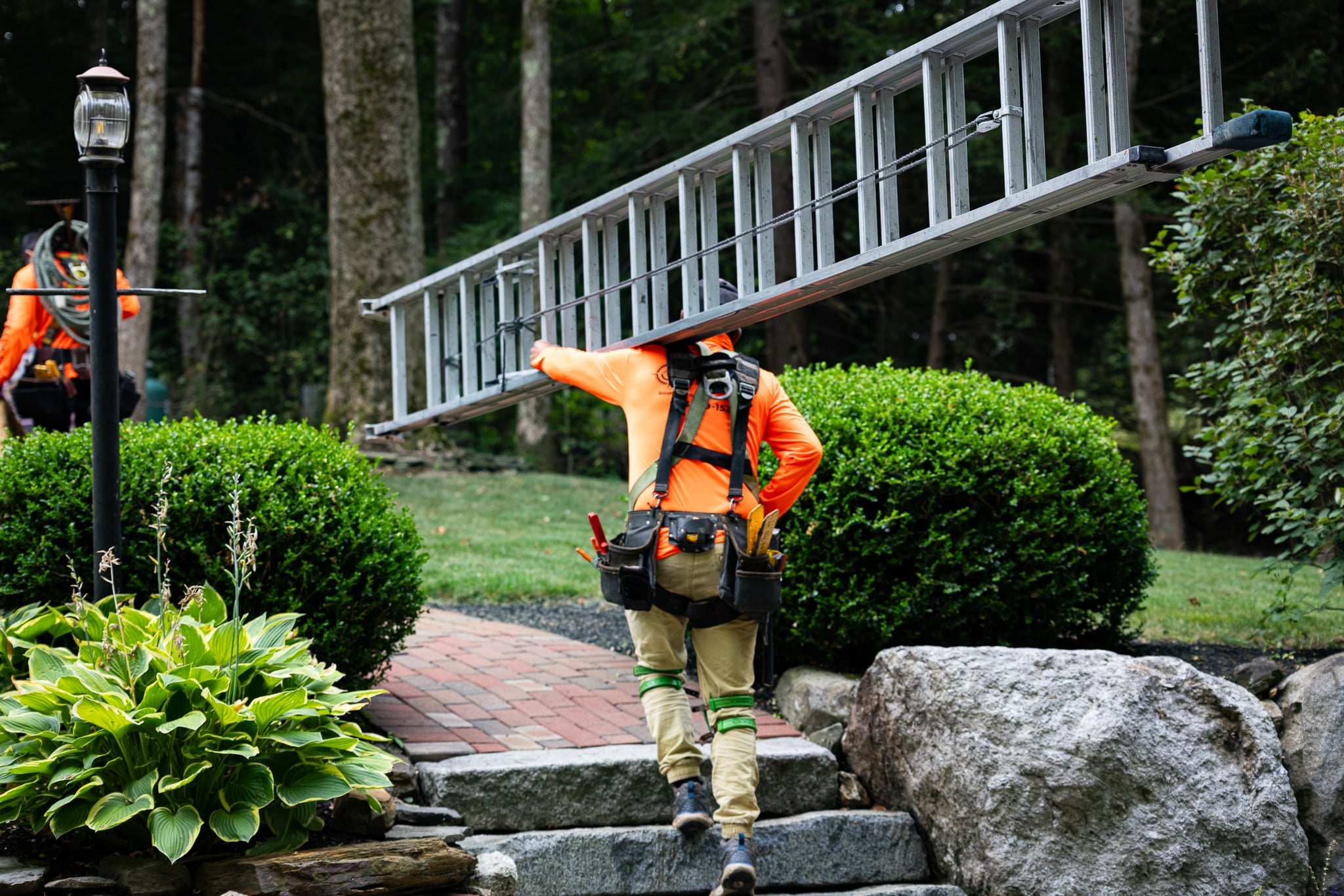 Compass Exteriors roofing crew installing Owens Corning shingles in Newfields NH
