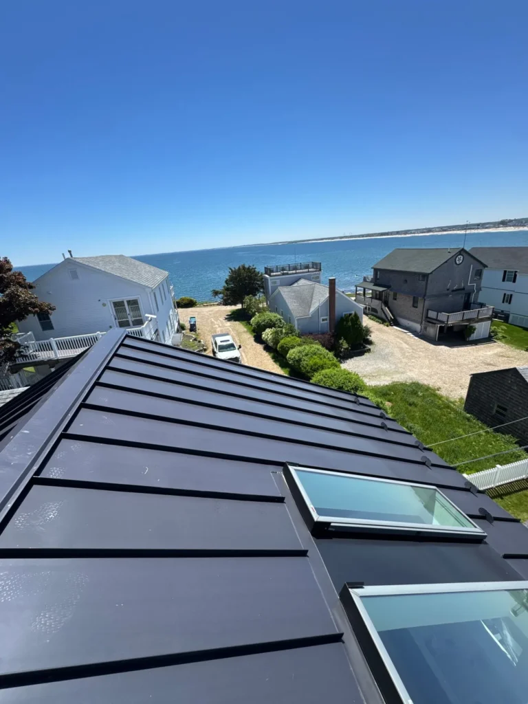 Dark standing seam metal roof with skylights overlooking the ocean in Hampton, NH